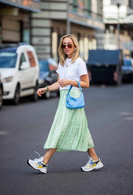  petite girl in green skirt and sneakers
