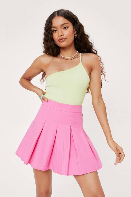 a  petite girl in pink skirt with yellow top 