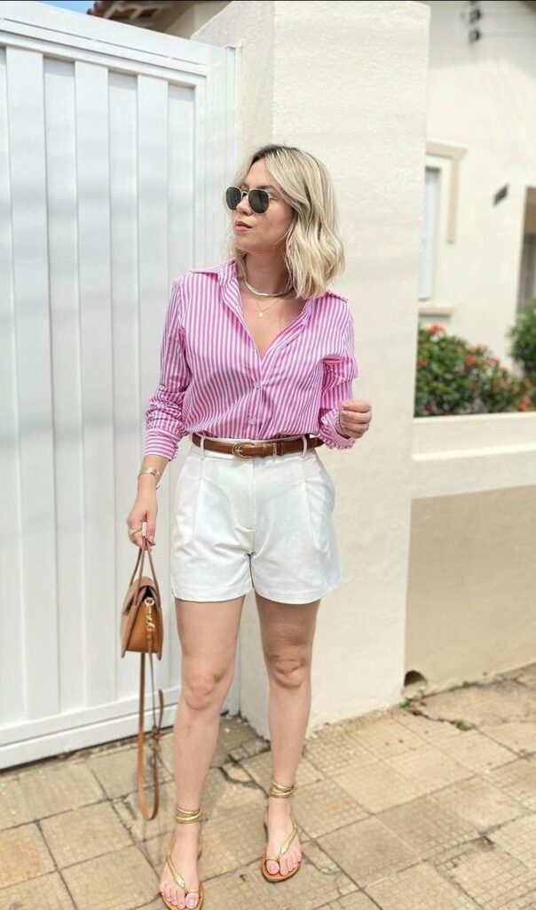 woman wearing pink striped shirt wearing white Bermuda shorts