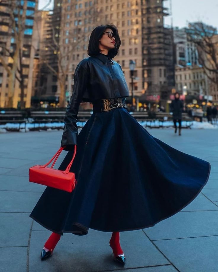 woman in all black outfit wearing East-West bags
