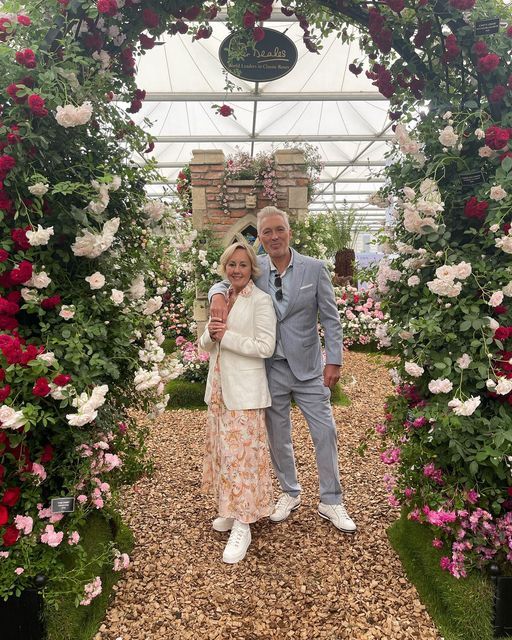 Older man and woman posing at the Chelsea Flower Show