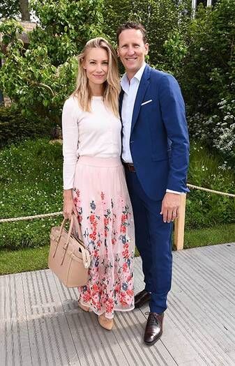 man and woman posing at the Chelsea Flower Show