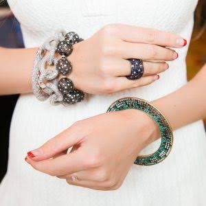 Two hands adorned with jewelry at the COUTURE Show Las Vegas