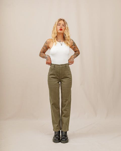 Tatoo blond girl wearing olive-green trousers