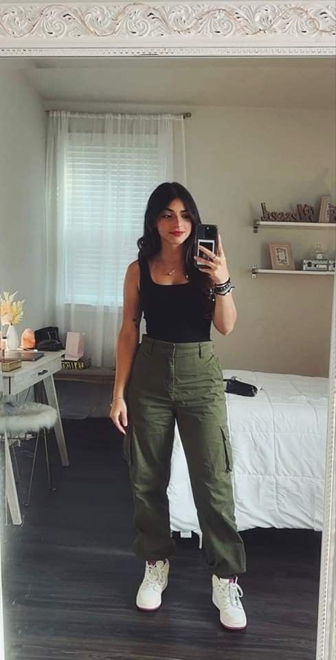 Darki haired girl wearing olive-green trousers