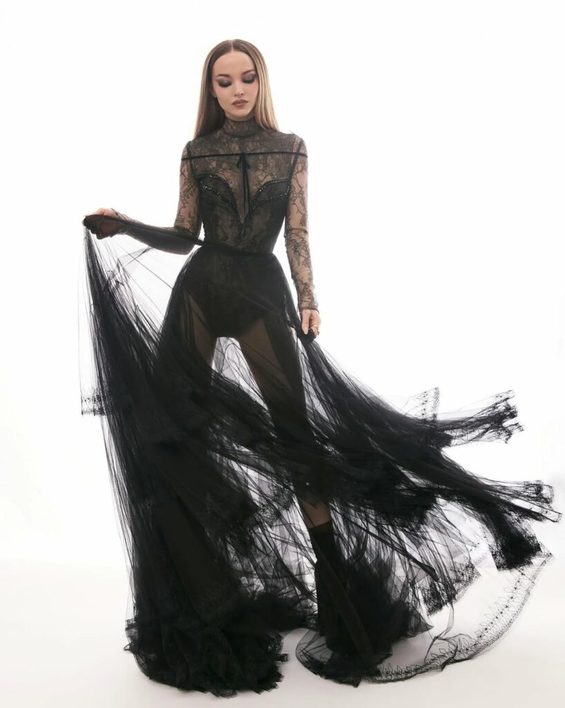Dove Cameron in Georges Chakra posing holding sheer skirt