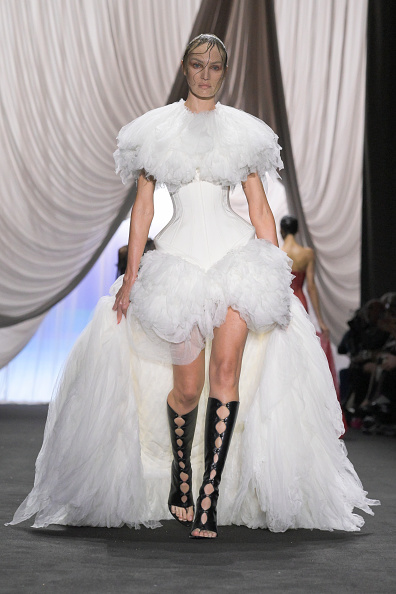 Jean Paul Gaultier Haute Couture’s Spring/Summer 2025 collection featured a short-sleeved silk tulle gown and knee-high gladiator thong boots.