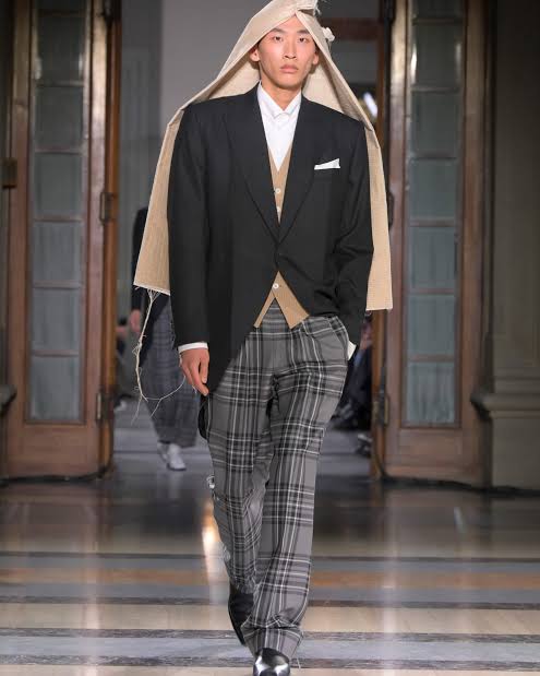 Asian man wearing suit with head covering at Pitti Uomo 2025
