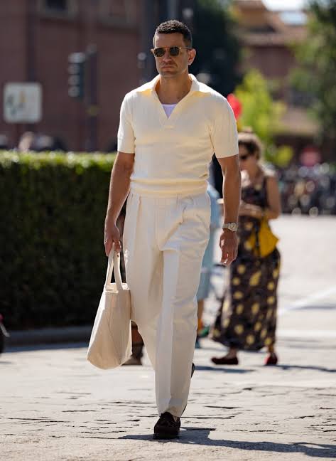 man wearing white pleated slacks with sport sweater at Pitti Uomo 2025
