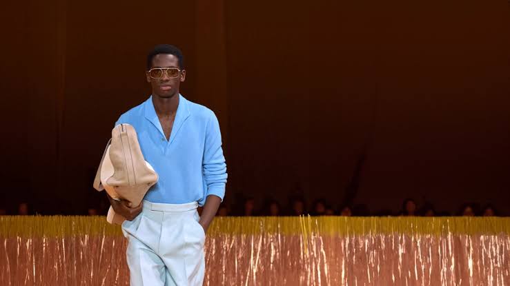 black man wearing white pleated pants at Pitti Uomo 2025