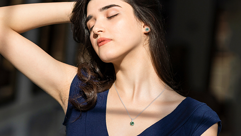 woman wearing  teal sapphires necklace