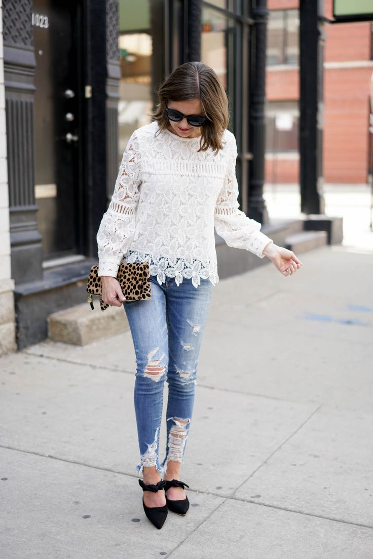woman in torn jeans and lace shirt