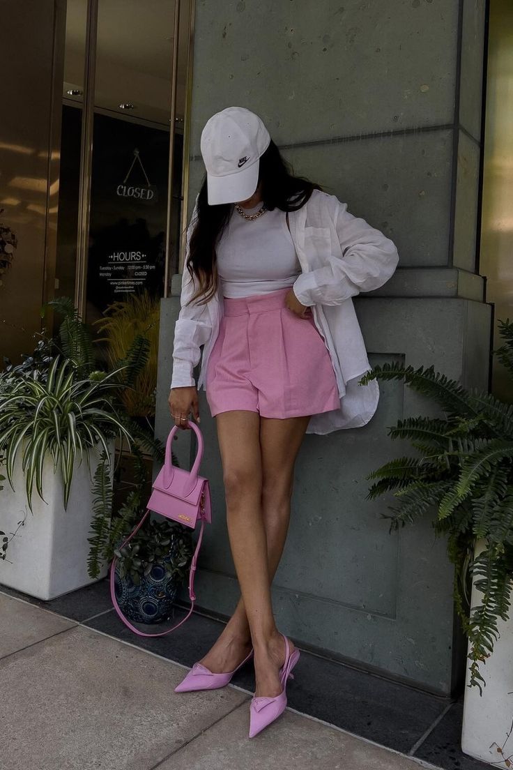 woman in pink shorts and white crop top summer wardrobe