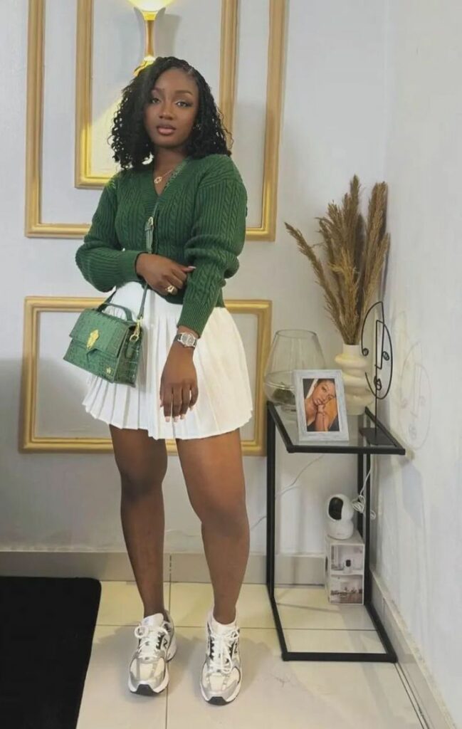 woman wearing green sweater and white bubble skirt