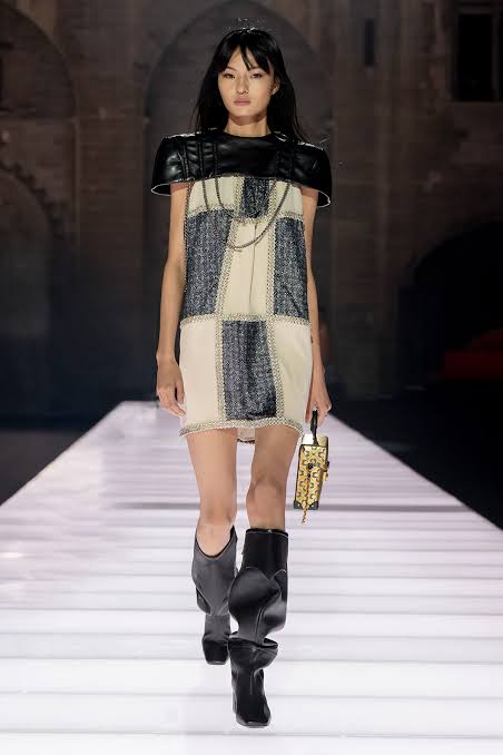 Asain girl wearing black checked outfit on the runway Cruise 2026 runway season