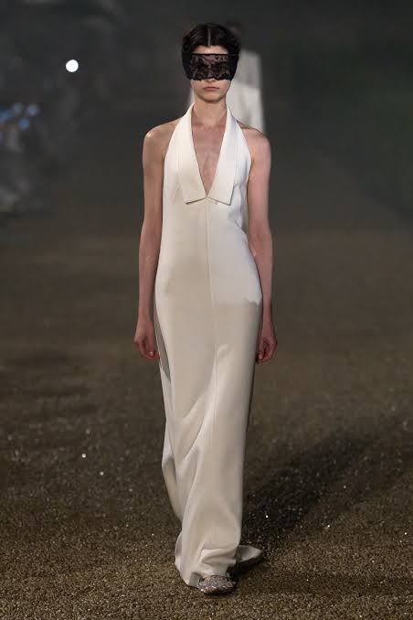 Model with black lace mask wearing Dior on the runway Cruise 2026 runway season