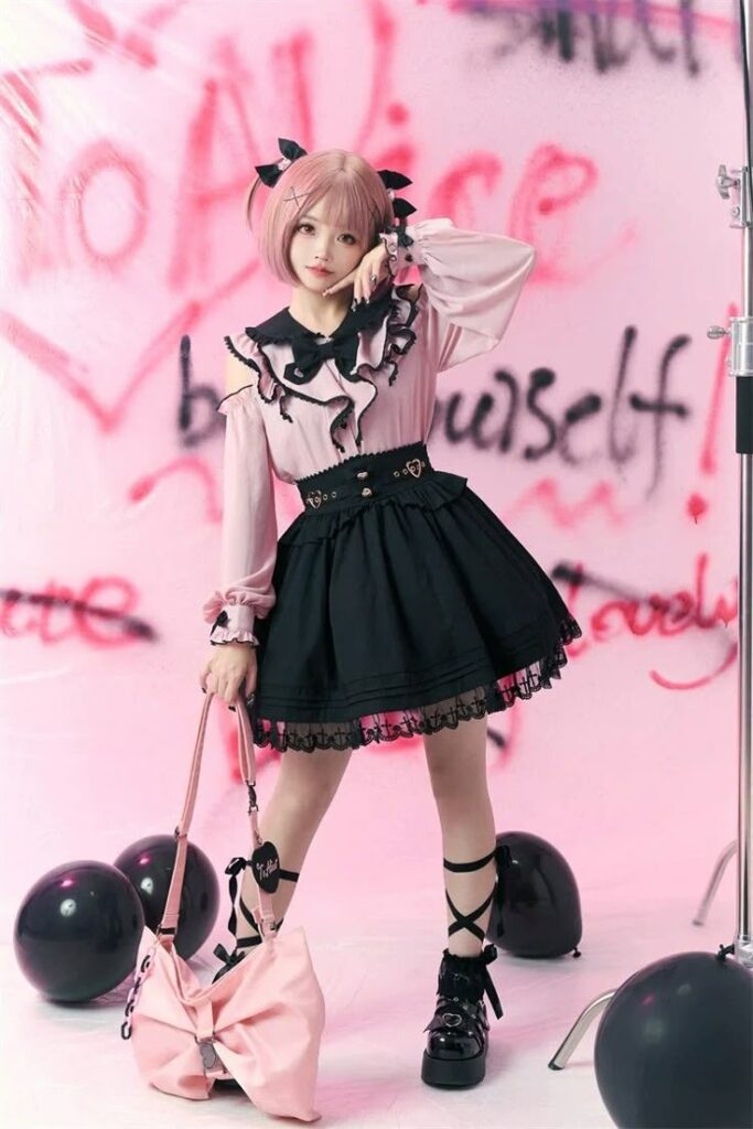 Japanese Girl in pink hair with pink top and black cocktail dress dispalys the new Jirai Kei trend