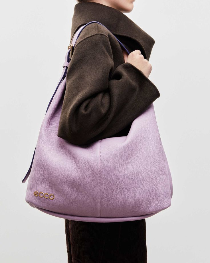 woman in brown suit with a nylon bag