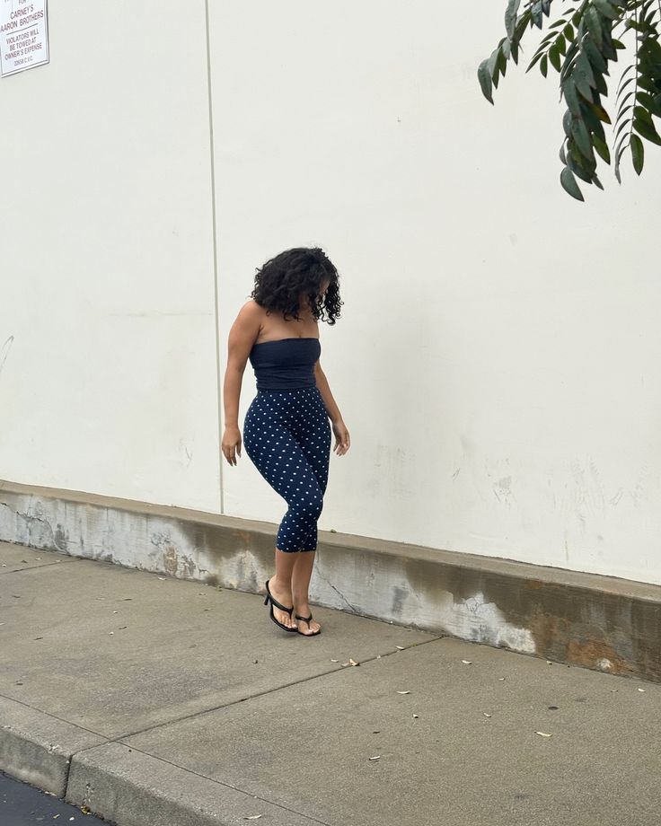 Curly haired brunette girl with blue and white Polka dot capri pants