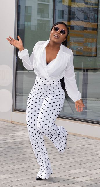 girl wearing white open top with white Polka dot capri pants