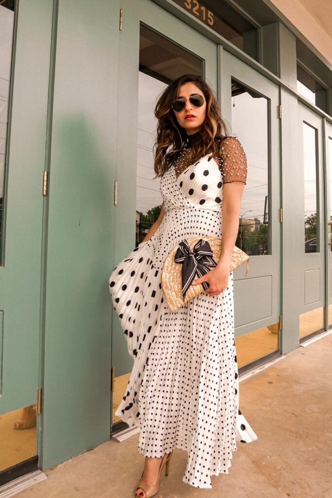 woman in flowing polka dot dress with varying size dots