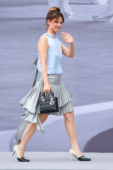 Mia Goth looked incredible with a pleated skirt and a small Lady Dior purse at the Dior Homme Menswear Spring/Summer 2026 show in Paris on June 27, 2025.
