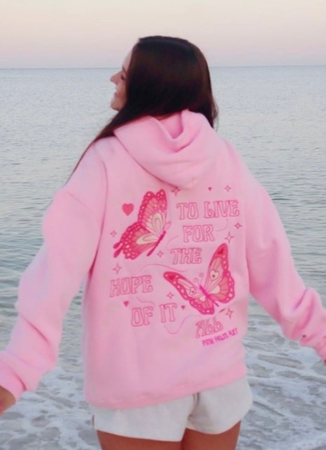 Girl in white shorts and Pink Palm Puff Hoodie
