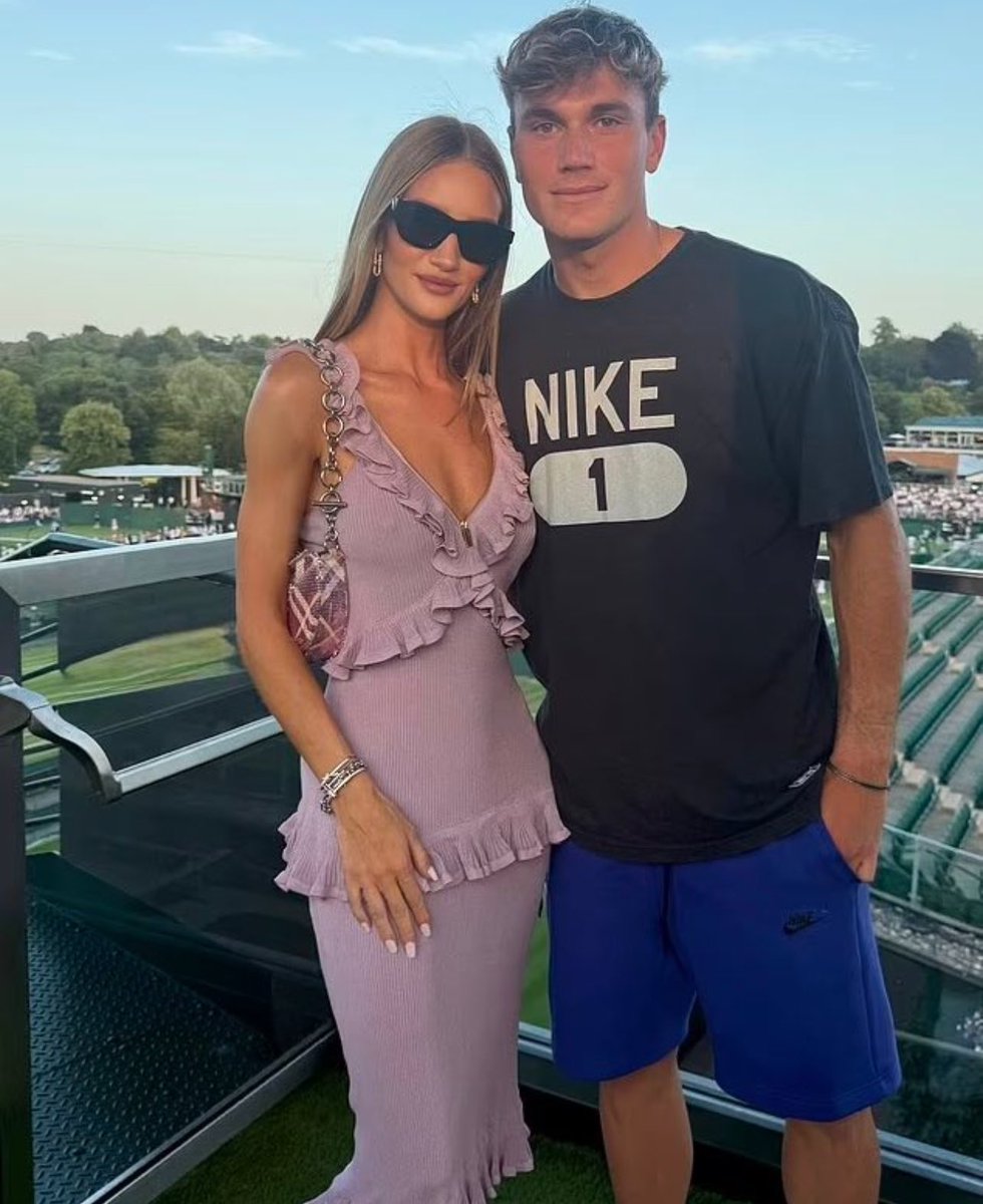 Rosie Huntington-Whiteley attended the third day of the 2025 Wimbledon Championships at the All England Lawn Tennis and Croquet Club in London, England, dressed in a Burberry ruffled silk midi dress and Shield Facet cat-eye sunglasses.