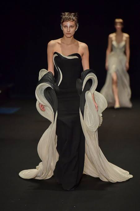 model wearing a flowy blck and white dress at the Paris Haute Couture Show