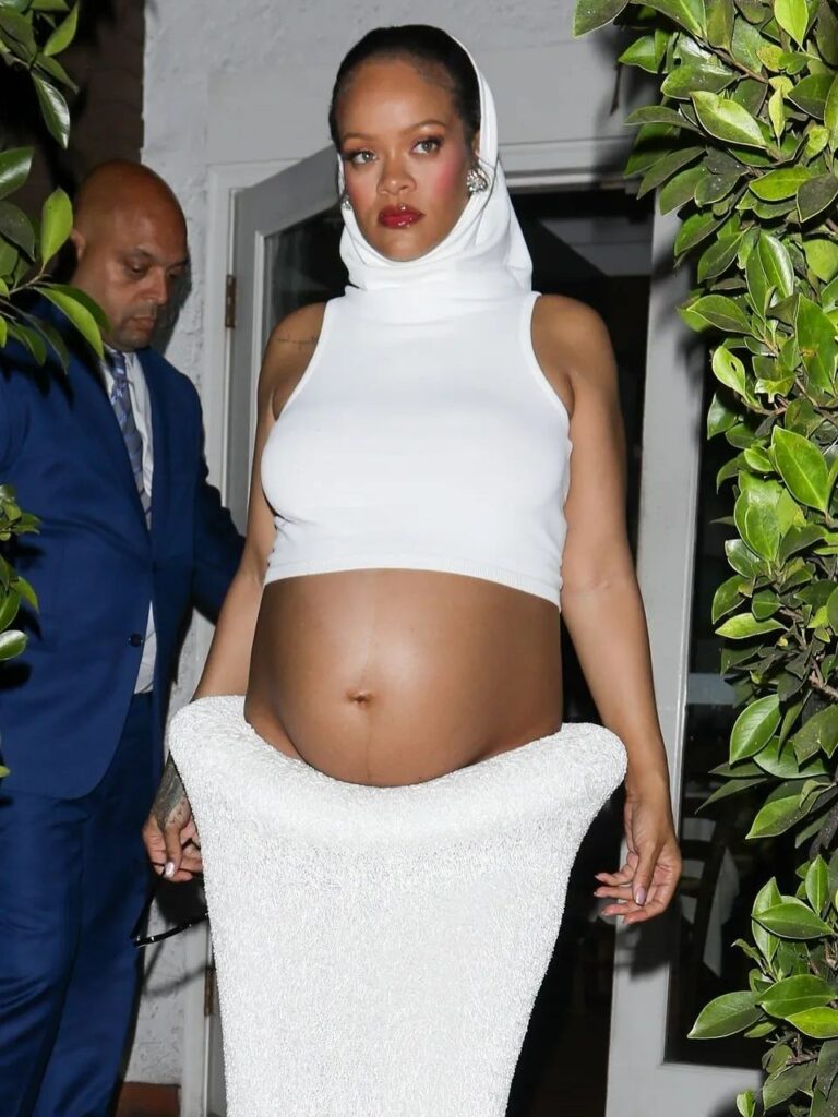 Rihanna in Alaïa Midriff Hoodie walking through door 
