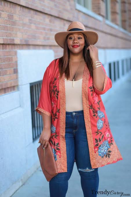 Black woman in plus sized jeans and long smock