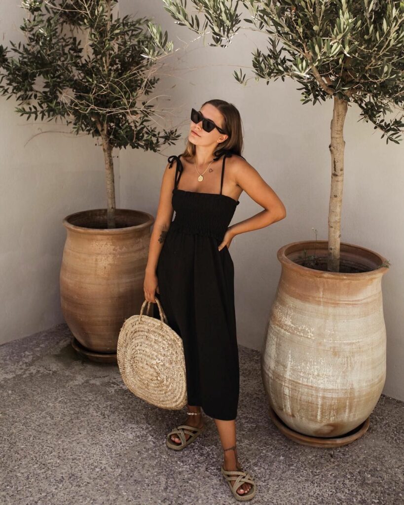 Woman in balck dress wearing rope sandals