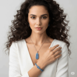 Dark haired woman in V neck wearing Kyanite jewelry