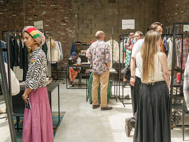 People browsing clothing racks at Welcome Edition New York