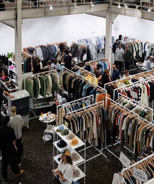 Clothing racks with fashion outits on them at the Welcome Edition New York