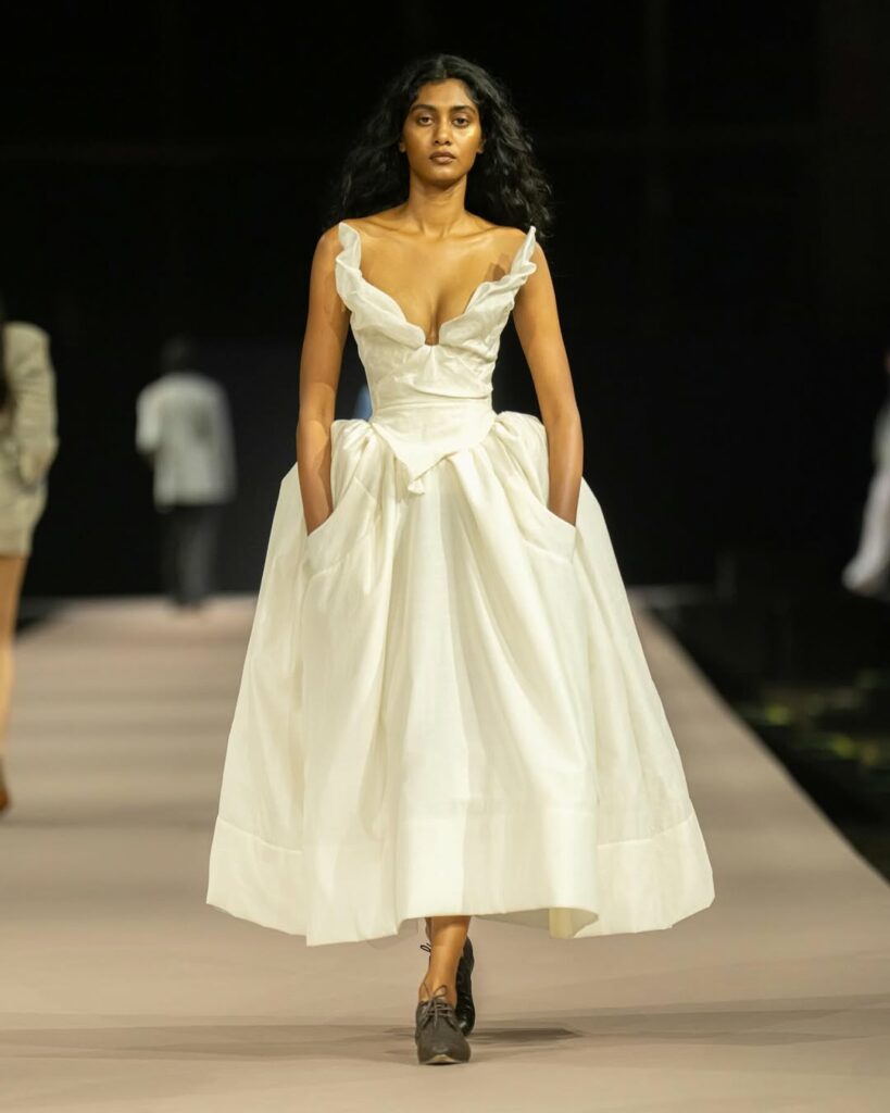 A model goes down the runway wearing a silk ball gown inspired by Simone Ashley for her presentation at the 2025 Cannes Film Festival.