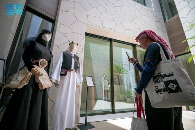 Saudi fashion woman taking pahot with phone of fashion outfit 