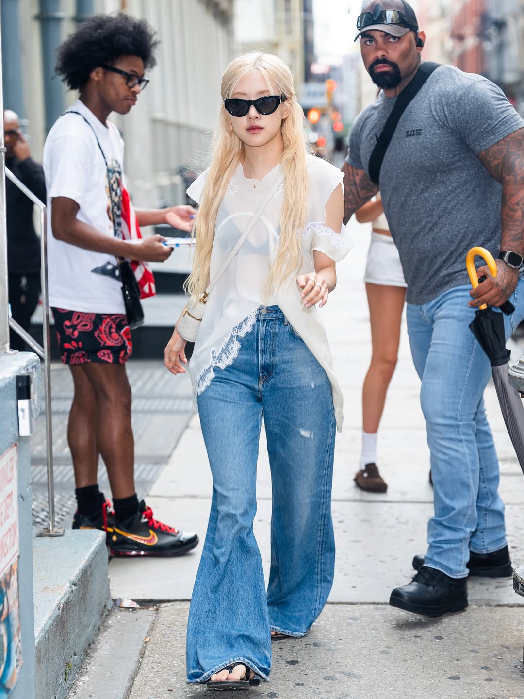 Blackpink Rosé looks stunning in SoHo on Friday, July 25th, 2025, wearing street-style ensembles, including The Row’s white translucent top and Acne Studios wide-leg jeans, ahead of the NYC Deadline World Tour.