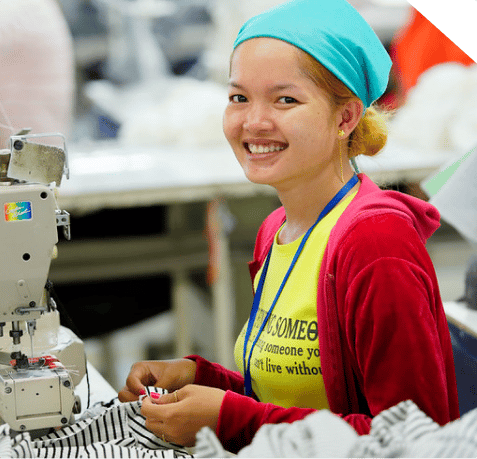 smiling girl sewing on a machine 