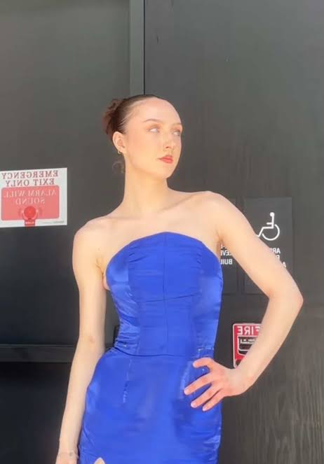 Model in blue off the shoulder dress