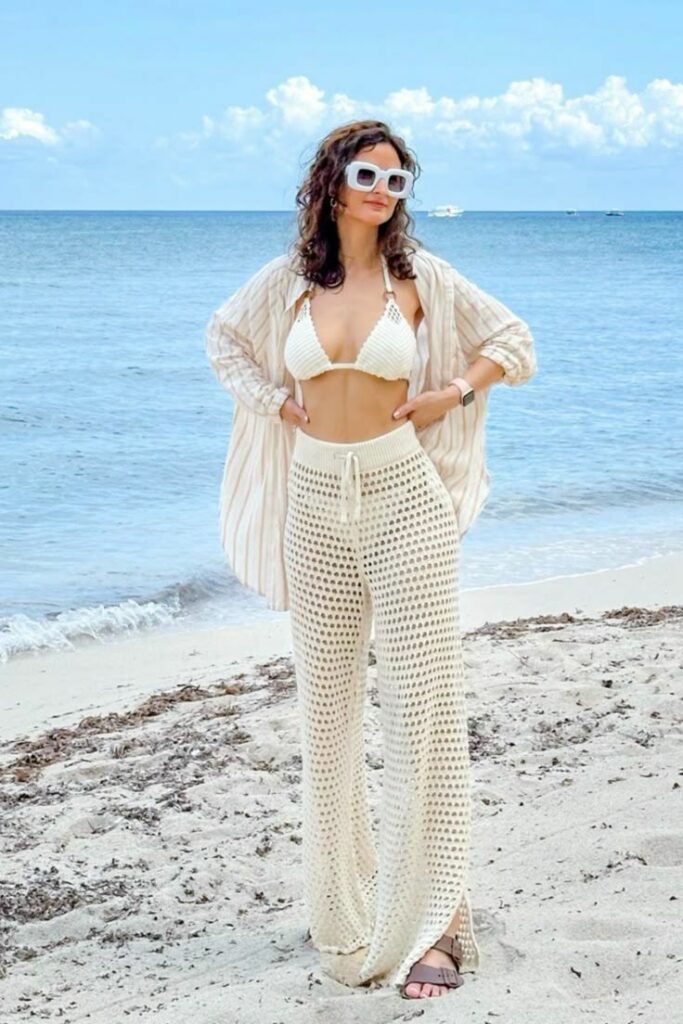 woman wearing Crochet pants at the beach over her bikini bottoms