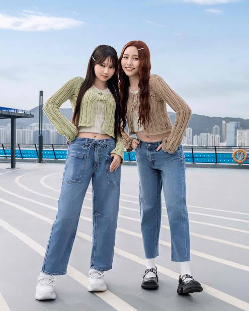two women wearing denim jeans