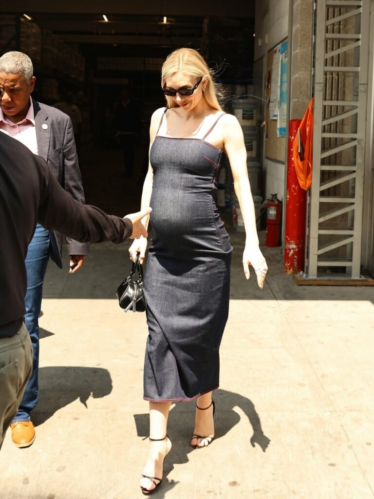 Vanessa Kirby wears a stylish Alaïa bodycon denim midi dress and Manolo Blahnik Paloma sandals while walking through New York City.