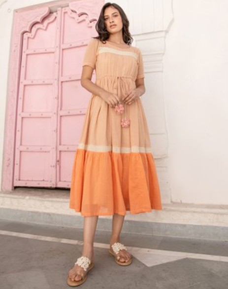 woman wearing orange sustainable style dress
