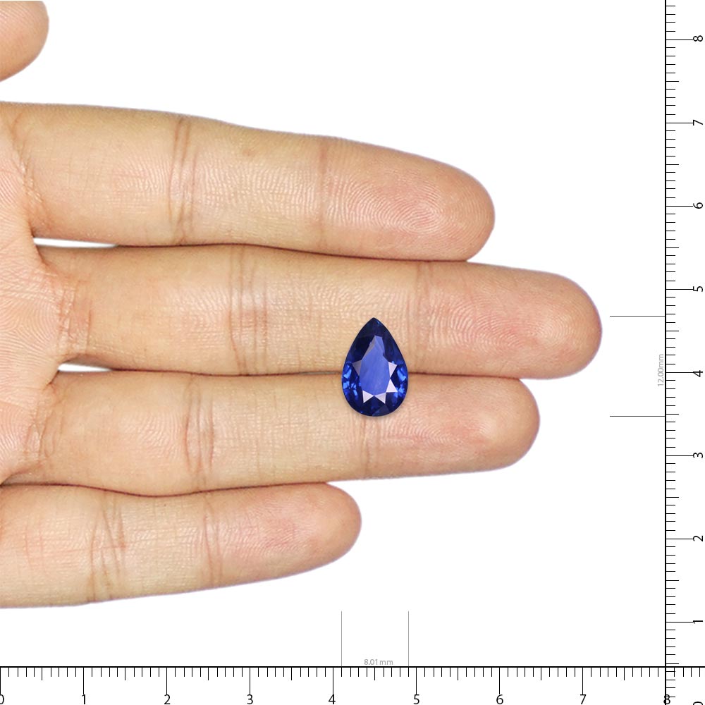 hand holding Blue sapphire stone