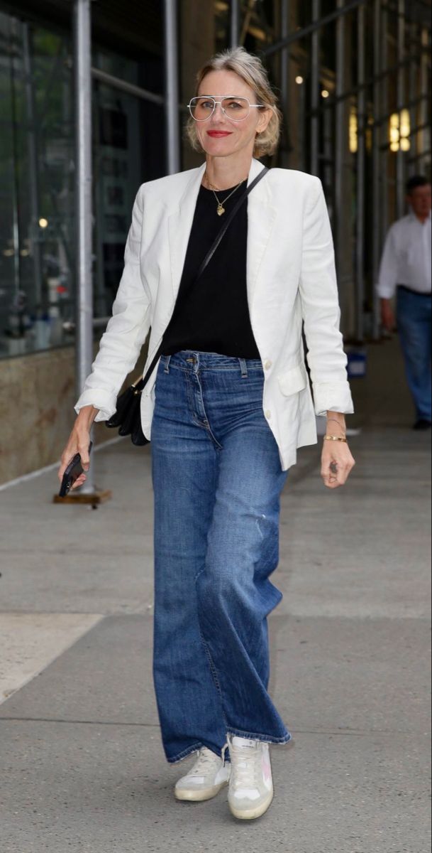 Naomi Watts in white jacket with black inner shirt paired with denim jeans