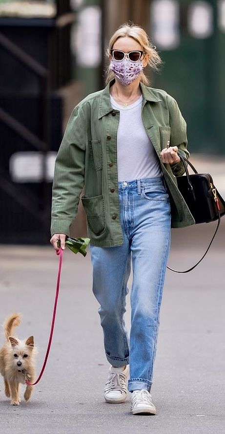 Naomi Watts in a casual layered top paired with denim jeans