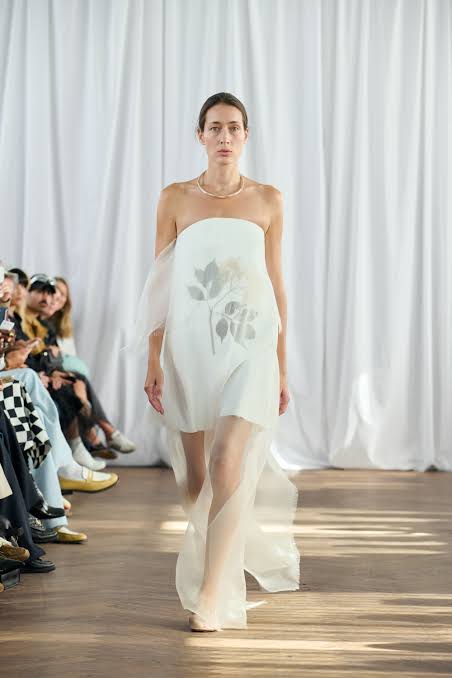 model wears white dress