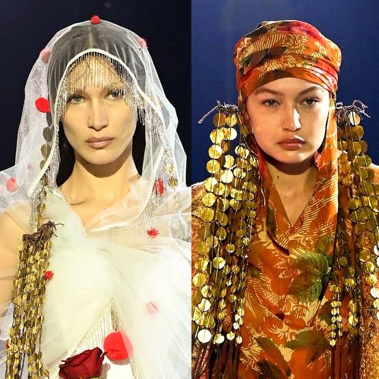 2 models wearing cultural outfits 