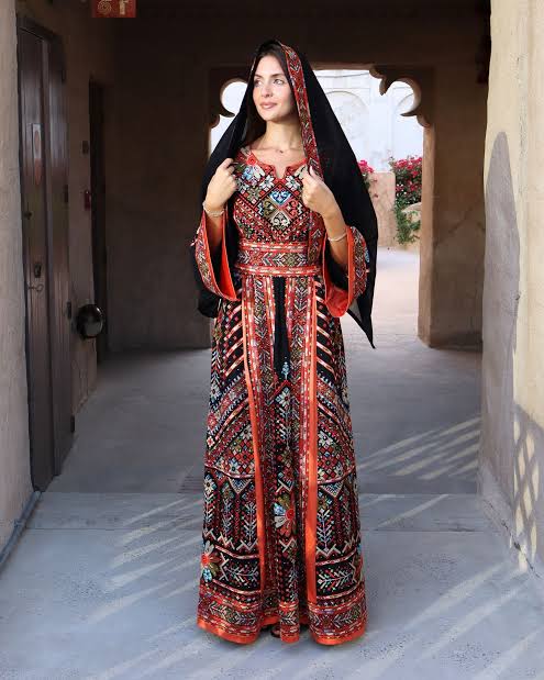model wearing blac and red Palestinian fashion outfit 